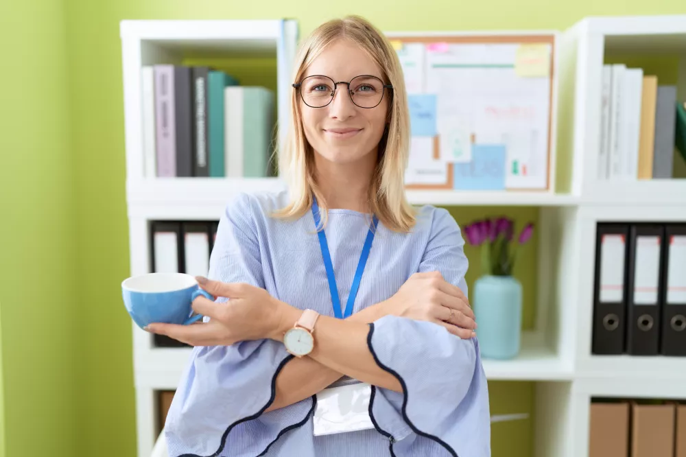 young-blonde-woman-business-worker-smiling-confident-drinking-coffee-office