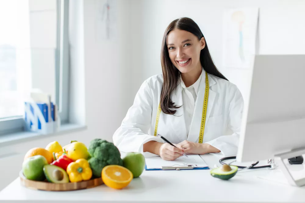 portrait-cheerful-female-dietologist-writing-healthy-eating-plan-weight-loss-diet-patient