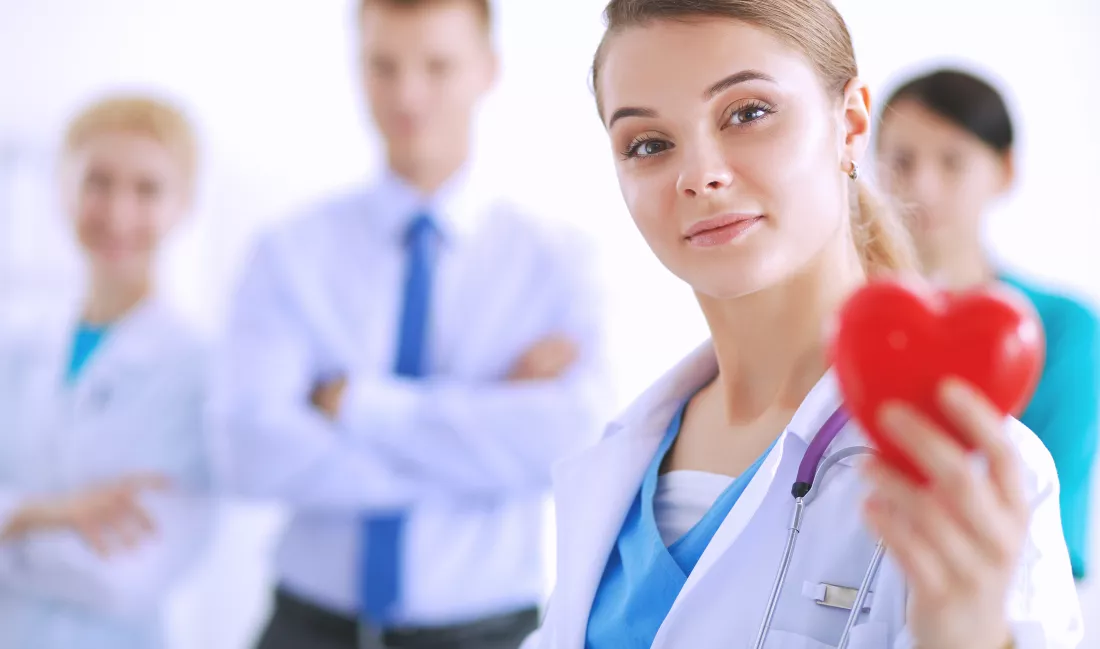 young-woman-doctor-holding-red-heart-isolated-white-background