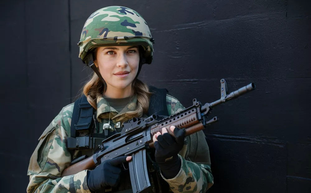 woman-camouflage-holds-gun-her-hand