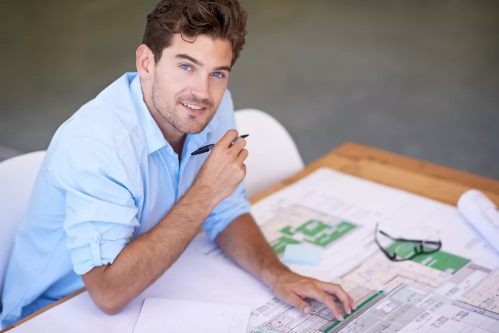 designing-perfect-office-space-shot-handsome-architect-working-his-plans