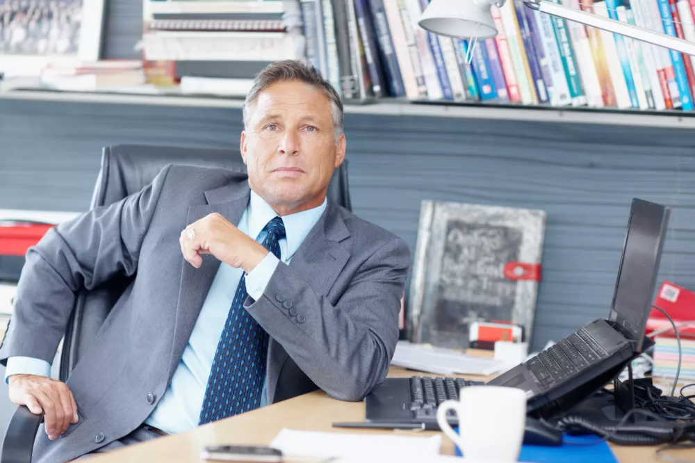 his-experience-is-second-none-portrait-formidable-business-manager-sitting-his-desk-copyspace
