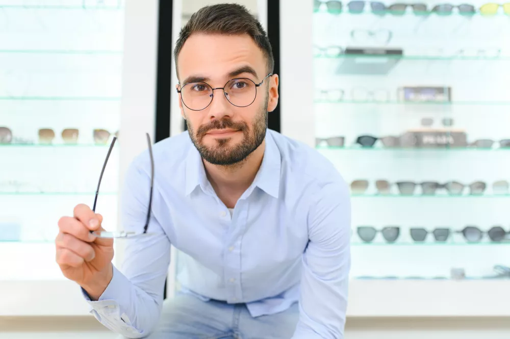 man-choosing-glasses-eyewear-store