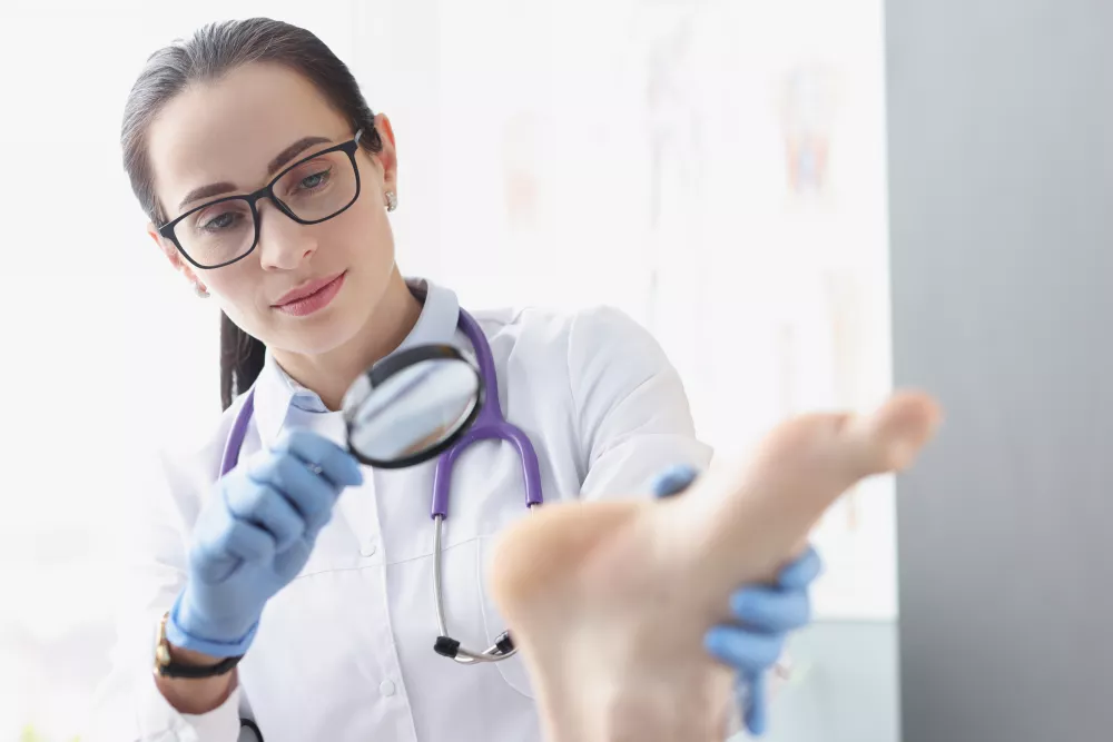 woman-podiatrist-examining-heel-patient-using-magnifying-glass